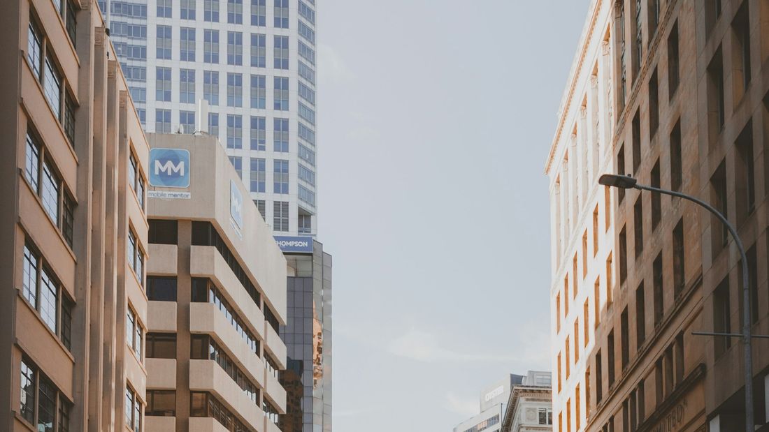 An Auckland CBD street with tall buildings rising behind it